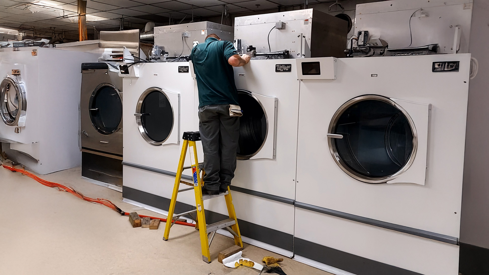 Professional technician servicing commercial laundry equipment